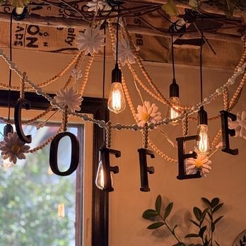 Edison bulbs and a COFFEE sign inside Causeway Coffee House