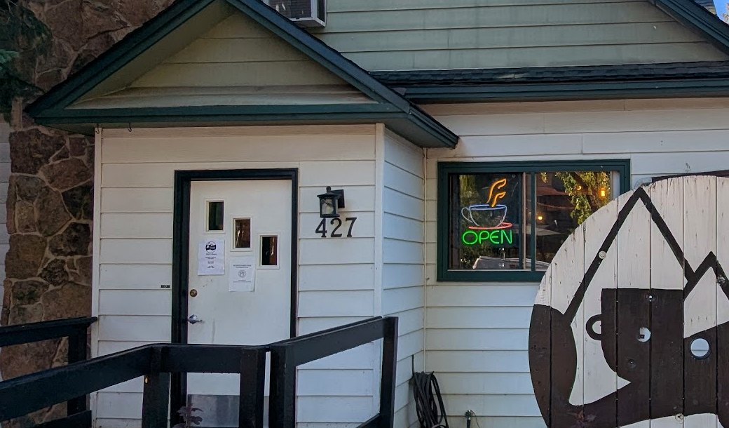 The front door of Causeway Coffee House at 427 Oak St, with the OPEN sign
